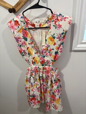 Mustard Seed floral mini dress featuring side cutouts and a v-neckline.